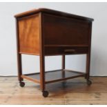 A MID 20TH CENTURY MAHOGANY SEWING TABLE, with a lift top, shelf below, on four casters, 63 x 62 x
