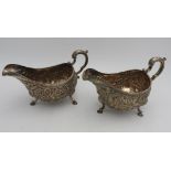 A PAIR OF IRISH HALLMARK SILVER SAUCEBOATS, with ornate floral embossed decoration with ornate