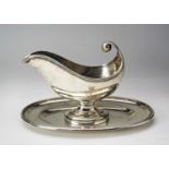 CONTINENTAL SILVER GRAVY BOAT  EARLY 20TH CENTURY  of boat shape form, raised on an attached oval