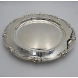 TWO LARGE PERUVIAN SILVER SERVING DISHES BY CAMUSSO, the larger with lotus flower motif to the