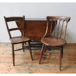 AN OAK GATE-LEG TABLE WITH TWO VICTORIAN SIDE CHAIRS AND A WICKER LOG BASKET, the gate-leg table