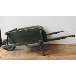 A FRENCH RUSTIC GREEN PAINTED WHEELBARROW, the original wheel replaced with a later addition, 63 x