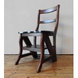 A METAMORPHIC HARDWOOD LIBRARY CHAIR, the hinged seat folding over to form a four tread library