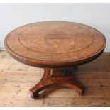 A GEORGE IV BURR WALNUT CIRCULAR TOP DINING TABLE ON CARVED CENTRAL PEDESTAL