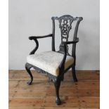 A 19TH CENTURY ORNATE CARVED MAHOGANY ELBOW CHAIR, with an pierced carved splat back with ribbon and