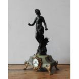 A 19TH CENTURY ONYX MANTLE CLOCK WITH LARGE CAST METAL FIGURINE DECORATION, on gilded cast metal