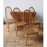 AN ERCOL LIGHT WOOD DROP-LEAF TABLE AND FOUR ERCOL HIGH BACK SPINDLE CHAIRS, the chairs measuring 97