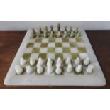 AN ONYX CHESS SET WITH BOARD, in fitted case, 35 x 45 cm