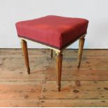 A CONTINENTAL 19TH CENTURY GILT WOODEN STOOL, the upholstered square seat supported by four