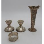 A PAIR OF HALLMARK SILVER CANDLESTICKS, HALL MARK SILVER VASE AND NAPKIN RING, the silver trumpet
