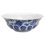 BLUE AND WHITE MOULDED 'LOTUS' BOWL JIAQING SEAL MARK AND OF THE PERIOD the moulded sides painted in