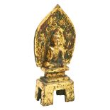 GILT-BRONZE FIGURE OF A SEATED  BUDDHA PROBABLY NORTHERN WEI DYNASTY (386-534 AD) on a tall base