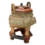 ARCHAICISTIC BRONZE TRIPOD CENSER  QING DYNATY, 19TH CENTURY with a fitted hardwood stand and cover,