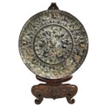 BRONZE MIRROR TANG DYNASTY (AD 618-907) the circular bronze mirror cast in relief with mythical