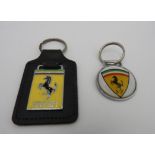 ONE FERRARI KEYRING WITH LEATHER FOB AND ONE ROUND FERRARI KEYRING These are original dealer items