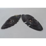 Matched pair of tribal masks with cowrie shell eyes, 36cm & 42cm high respectively