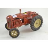An unboxed vintage Lesney diecast large scale model of a Massey Harris 745D Tractor in red with lemo