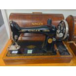 Manual Singer sewing machine with engraved end plate and case.