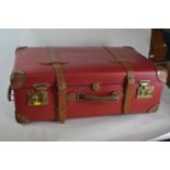 A Red Globe-trotter wheeled suitcase with leather straps and handle. 70 x 42 x 22cm.