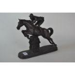 A BRONZE RESIN FIGURE of a horse and jockey, signed Tupton on oval base, 28 cms x 25 cms.