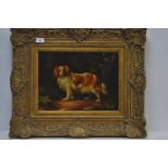 C19 oil on board of a spaniel standing, in an ornate gilt frame. 65cm x 55xm inclusive of frame