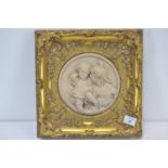 Marble relief plaque of children in ornate gilt frame. 29cm x 29cm