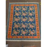 Rose patterned wool rug, with floral borders. 161cm x 195cm