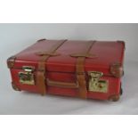 A Red Globe-trotter pull along suitcase with leather straps and handle + keys. 55 x 40 x 17cm.