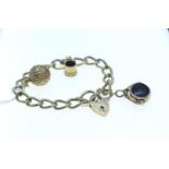9ct gold bracelet with heart-shaped padlock clasp, suspending three charms including two 9ct gold &a