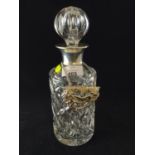 Cut glass brandy decanter with silver rimmed neck.