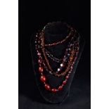 Five red amber style bead necklaces