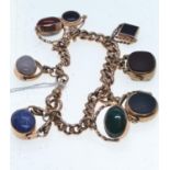 9ct gold bracelet suspending eight hardstone set swivel fobs, 205mm circumference, gross weight 70.1