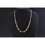 9ct gold, garnet &amp; gem-set necklace, circumference 420mm, 14.78 grams