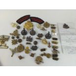 Collection of military badges, buckles and buttons, includes Royal Engineers, Sherwood Foresters, Ro