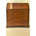 An Edwardian inlaid mahogany writing bureau, with fall front revealing fitted interior, above 1 shor