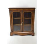 An Edwardian mahogany bookcase. 2 glass front doors over bracket supports. Includes key. w92cm d31cm