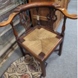 Early C20th oak corner chair with rush seat