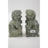 Pair of carved dogs of fo figures, 21cm high