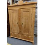 Stripped pine double wardrobe with pediment and claw feet. two lower drawers plus key present. W127c