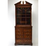 Theodore Alexander mahogany library bookcase, with a broken architectural pediment centered by the S