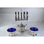 Silver cruet set with blue glass liners, maker WD, Birmingham 1911, a toast rack, maker CWF, Sheffie