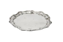 An Edwardian silver shaped circular salver by Joseph Rodgers & Sons