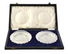A cased pair of silver shaped circular butter dishes by George Unite & Sons