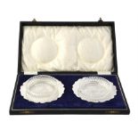 A cased pair of silver shaped circular butter dishes by George Unite & Sons