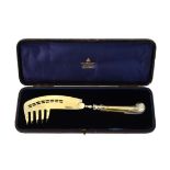 A cased silver gilt pistol grip handled melon server