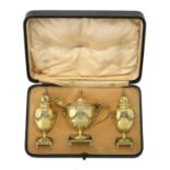 A cased matched Edwardian silver gilt three piece cruet set