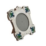 An Art Nouveau silver mounted and enamel shaped square photo frame by William Hutton & Sons Ltd.