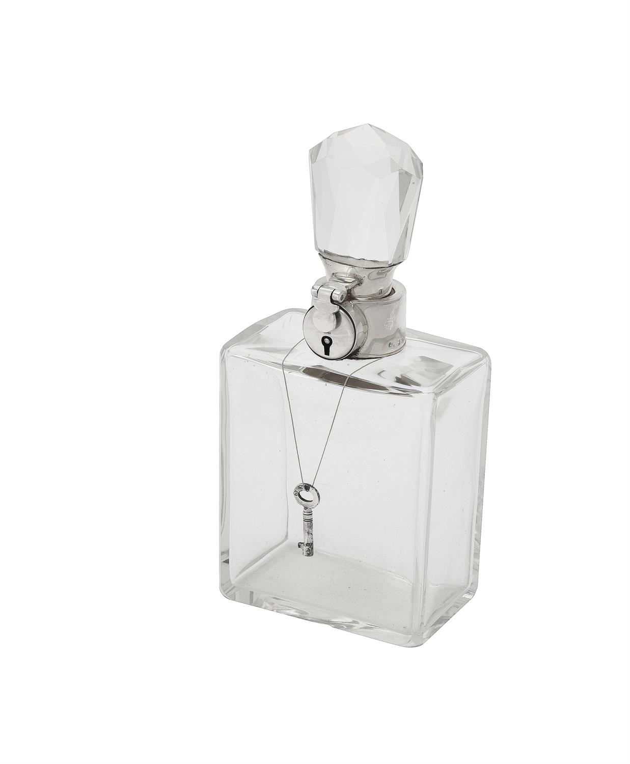 A silver mounted lockable glass decanter by Hukin & Heath Ltd.