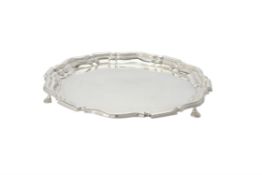 An Edwardian silver shaped circular salver by Mappin & Webb