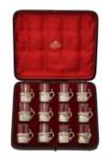 A cased set of twelve Victorian silver mounted liqueur glasses by William Comyns & Sons Ltd.